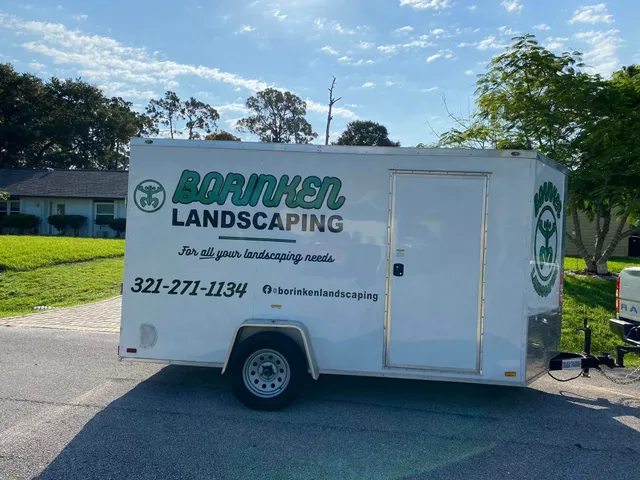 Borinken Landscaping branded trailer, parked curbside, with logo, phone number, and Facebook handle visible